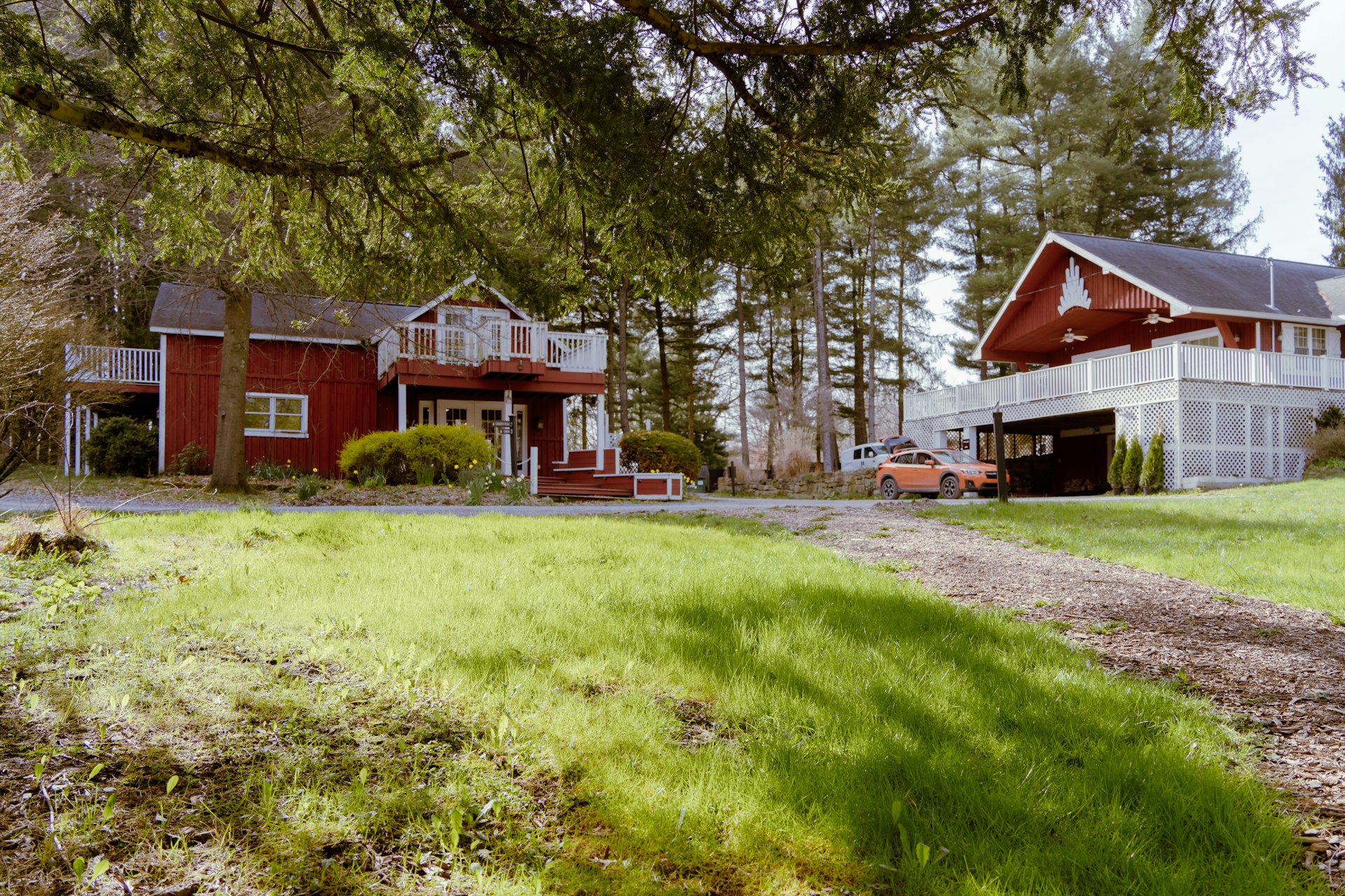 a red house with a car parked in front of it